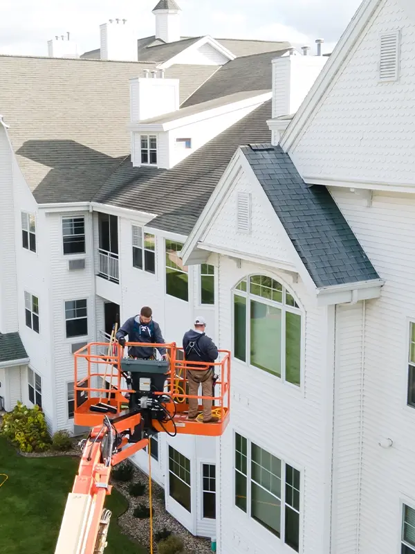 commercial roofers on a cherry picker